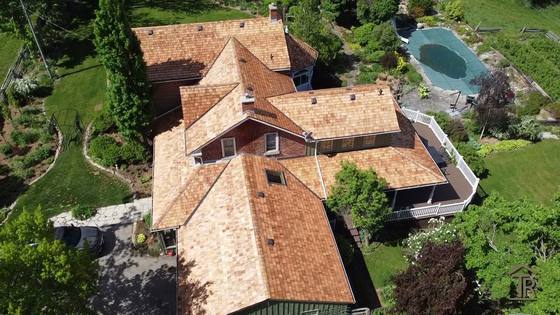 Drone flyover of a completed cedar shake roof on a Wellington County home